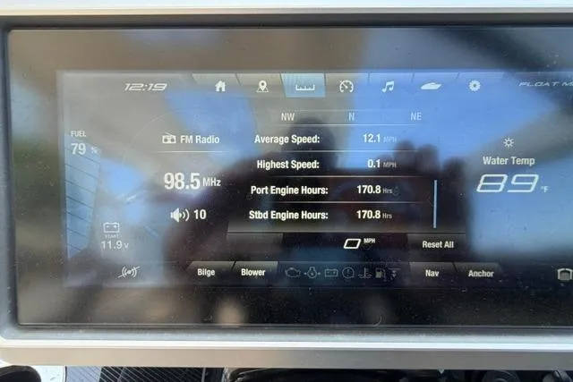 Slide: The Image of Dashboard display of a 2021 Yamaha Boats 275SD showing FM radio and engine data. - 30