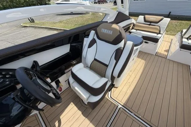 Slide: The Image of 2021 Yamaha Boats 275SD interior with luxurious seating and modern steering wheel. - 31