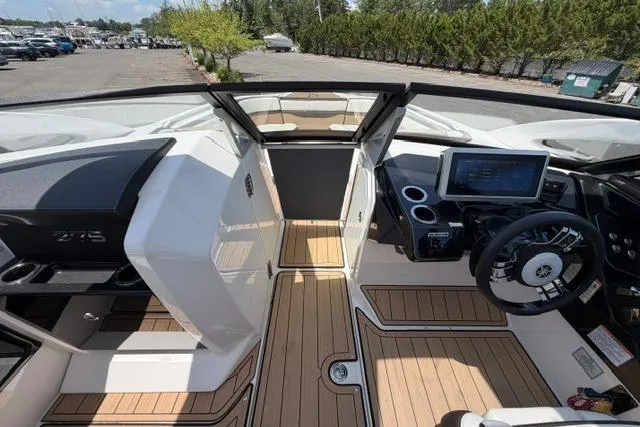 Slide: The Image of 2021 Yamaha Boats 275SD interior with sleek design, modern dashboard, and spacious seating. - 32