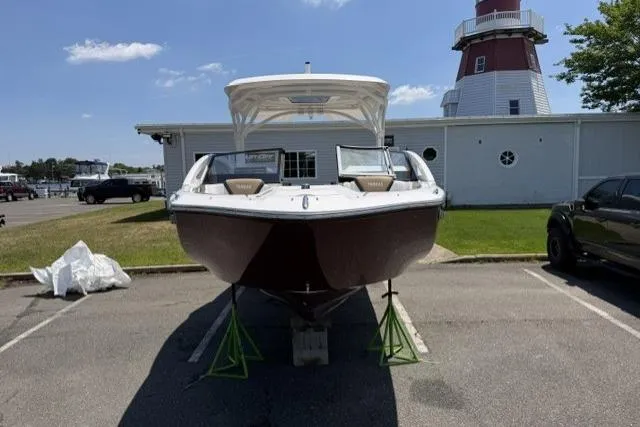 Slide: The Image of 2021 Yamaha Boats 275SD on display near a lighthouse, parked on a sunny day. - 8