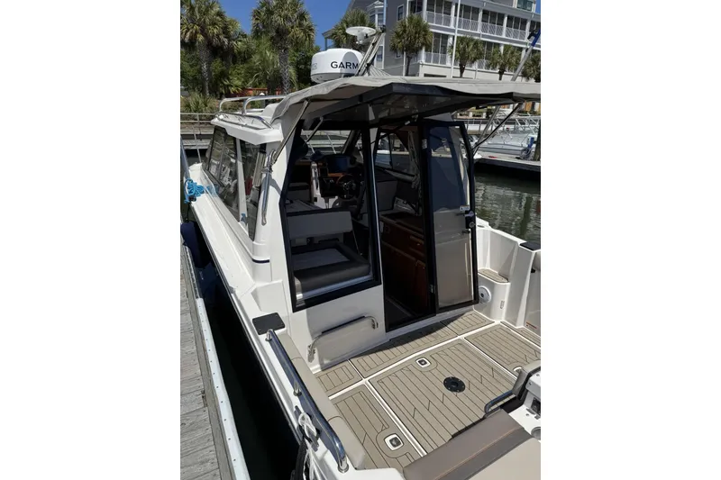 Slide: The Image of 2022 Cutwater C-248 Coupe docked, showcasing open cockpit and interior view. - 7