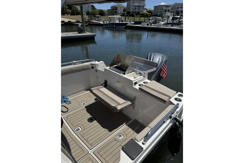 Slide: The Image of 2022 Cutwater C-248 Coupe boat interior with seating, docked in a marina. - 8
