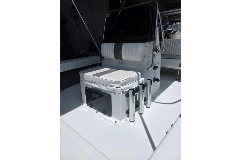 Slide: The Image of 1994 Action Craft Flatsmaster 1810 boat interior with seating and rod holders. - 3