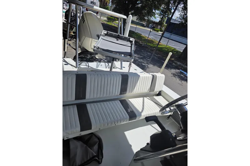 Slide: The Image of 1994 Action Craft Flatsmaster 1810 boat interior with seating and steering wheel. - 6