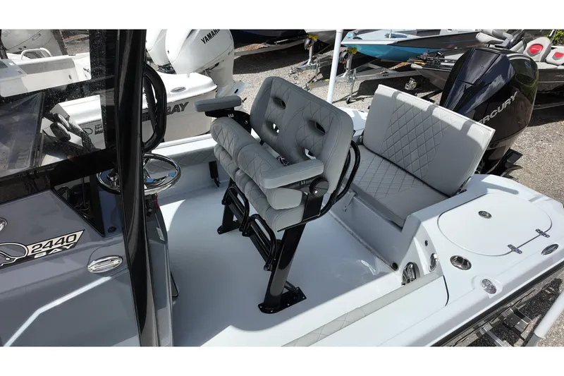 Slide: The Image of 2026 Blazer Bay 2440 boat interior with cushioned seating and steering console. - 11