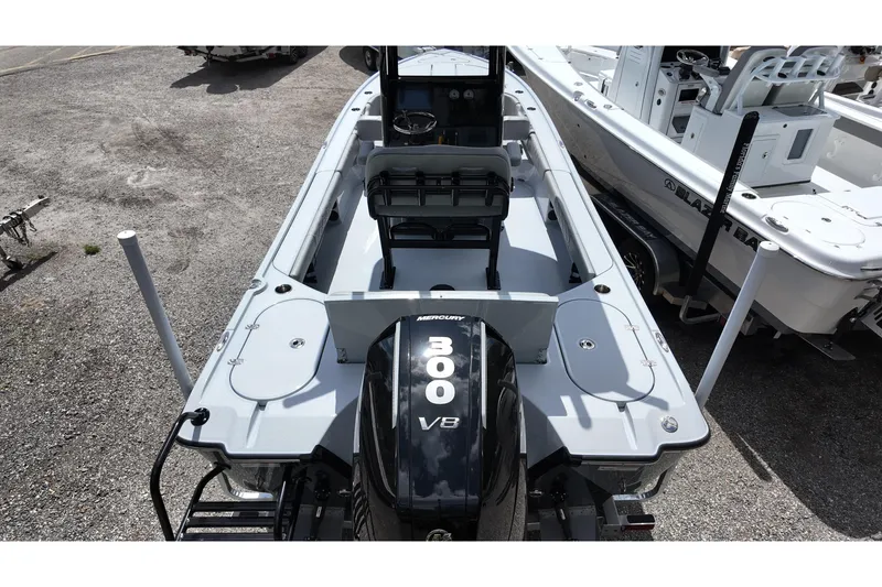 Slide: The Image of 2026 Blazer Bay 2440 boat with Mercury 300 V8 engine, docked outdoors. - 13