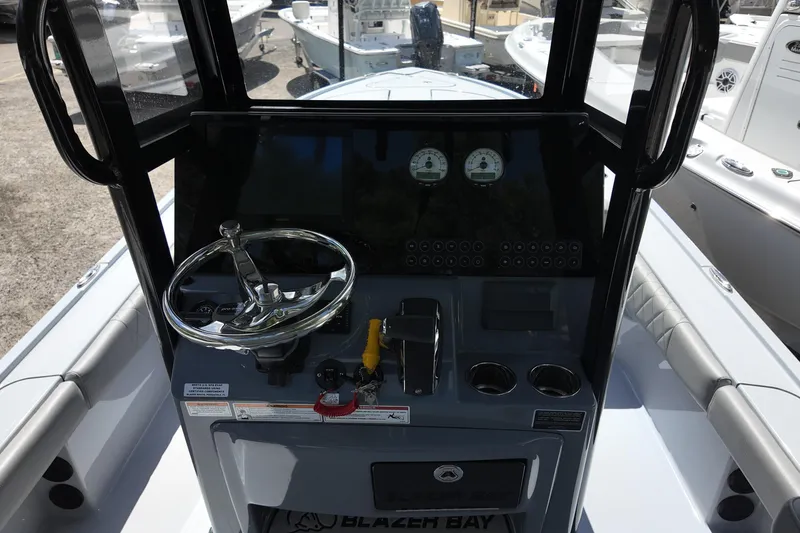 Slide: The Image of 2026 Blazer Bay 2440 boat console with steering wheel and controls. - 6