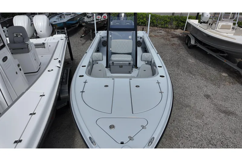 Slide: The Image of 2026 Blazer Bay 2440 boat, sleek design, parked on gravel lot. - 8