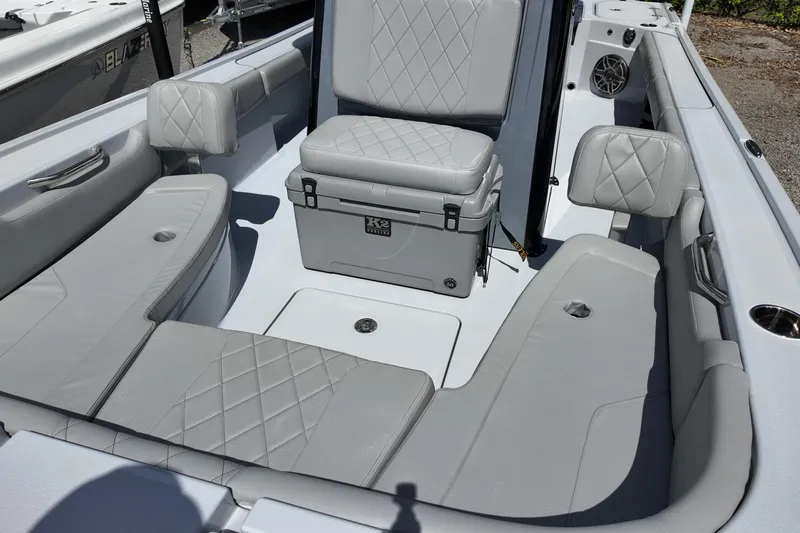 Slide: The Image of 2026 Blazer Bay 2440 boat interior with gray cushioned seating and storage. - 9
