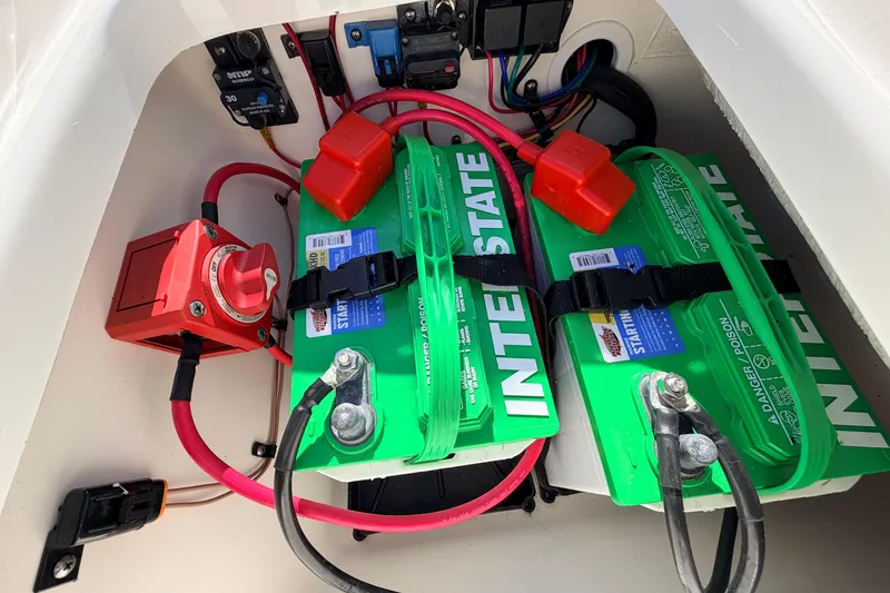 Slide: The Image of 2024 Key West 210 Bay Reef boat battery compartment with Interstate batteries and wiring. - 100
