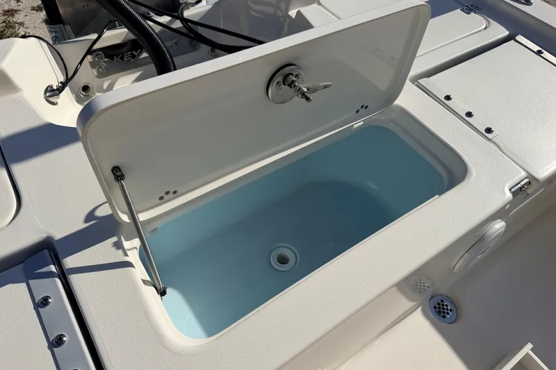 Slide: The Image of 2024 Key West 210 Bay Reef boat livewell with open lid, showcasing interior design. - 102