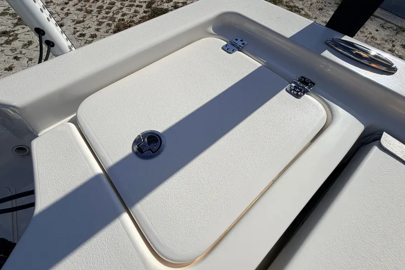 Slide: The Image of 2024 Key West 210 Bay Reef boat hatch with stainless steel hinges and textured surface. - 104