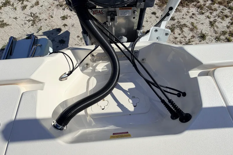 Slide: The Image of 2024 Key West 210 Bay Reef boat engine compartment with cables and hoses. - 107