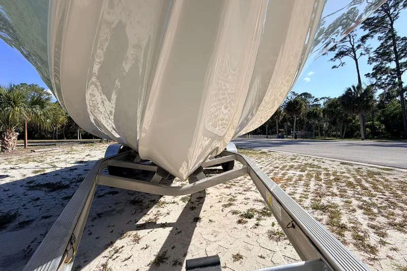 Slide: The Image of 2024 Key West 210 Bay Reef boat on trailer, parked outdoors on sandy ground. - 11