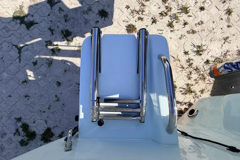 Slide: The Image of 2024 Key West 210 Bay Reef boat ladder on sandy ground. - 112