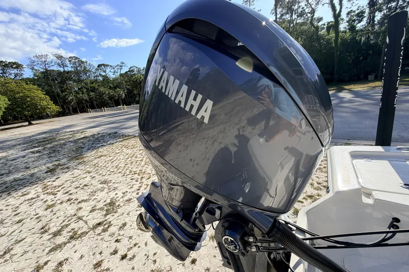 Slide: The Image of 2024 Key West 210 Bay Reef with Yamaha outboard motor in a scenic outdoor setting. - 113