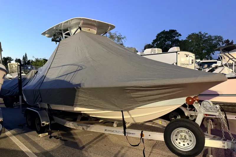 Slide: The Image of 2024 Key West 210 Bay Reef boat covered on trailer in parking lot. - 117