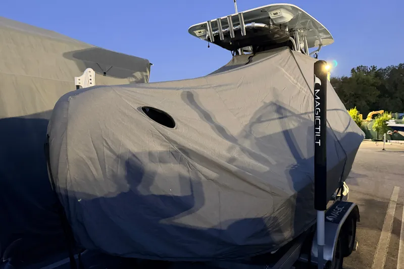 Slide: The Image of 2024 Key West 210 Bay Reef boat covered, parked on Magic Tilt trailer at dusk. - 118