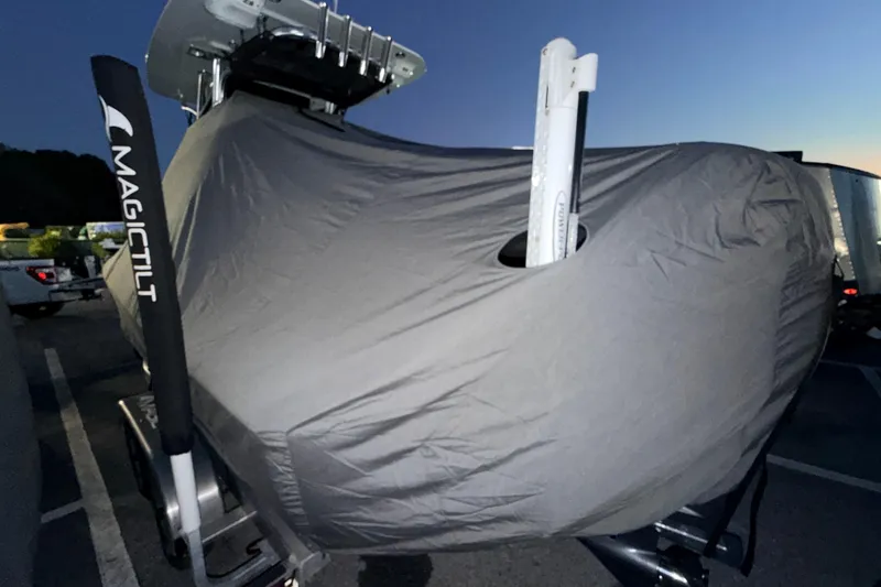 Slide: The Image of 2024 Key West 210 Bay Reef boat covered, on Magic Tilt trailer, at dusk. - 119