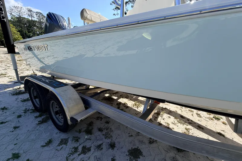 Slide: The Image of 2024 Key West 210 Bay Reef boat on trailer, side view, outdoors. - 13