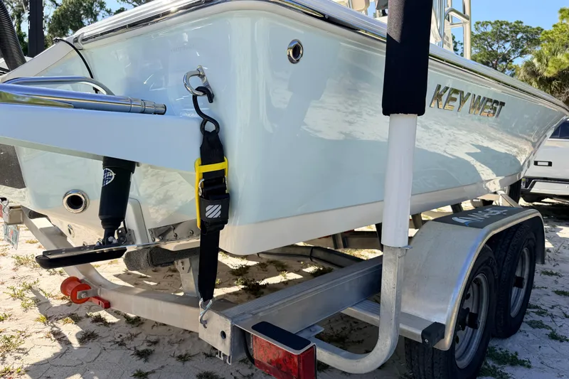 Slide: The Image of 2024 Key West 210 Bay Reef boat on trailer, parked outdoors. - 15
