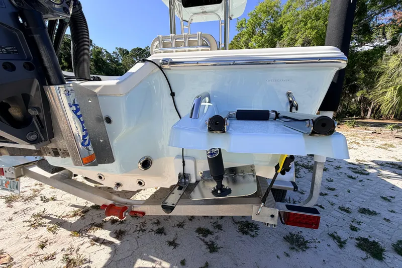 Slide: The Image of 2024 Key West 210 Bay Reef boat rear view, showcasing motor and trailer details. - 16