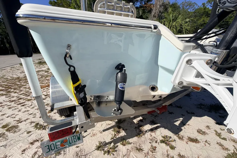 Slide: The Image of 2024 Key West 210 Bay Reef boat on trailer, rear view with license plate visible. - 19