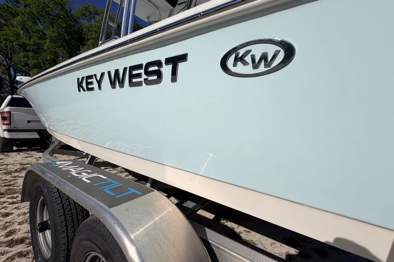 Slide: The Image of 2024 Key West 210 Bay Reef boat on Magic Tilt trailer, parked outdoors. - 21