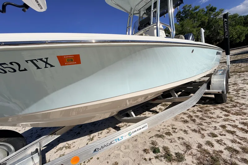 Slide: The Image of 2024 Key West 210 Bay Reef boat on trailer, Florida registration visible. - 22