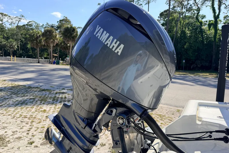 Slide: The Image of 2024 Key West 210 Bay Reef with Yamaha outboard motor in a scenic outdoor setting. - 25