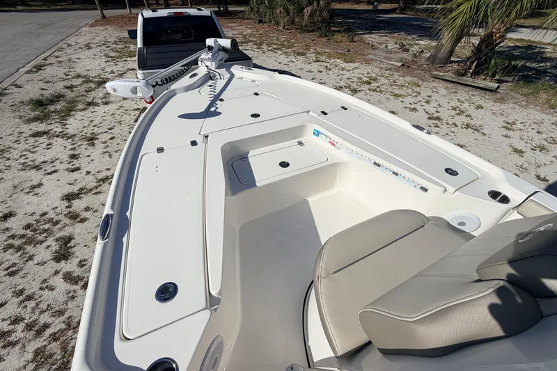 Slide: The Image of 2024 Key West 210 Bay Reef boat interior with seating and storage compartments. - 26