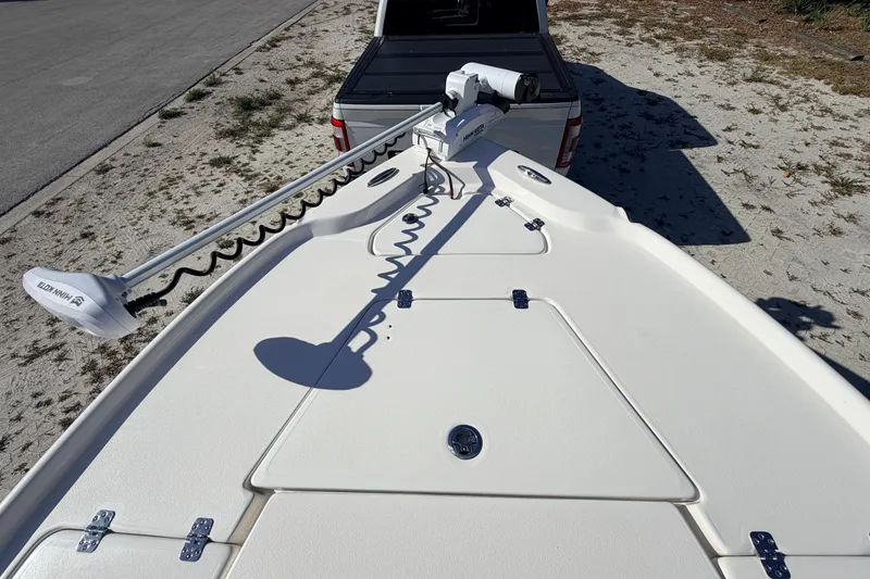 Slide: The Image of 2024 Key West 210 Bay Reef boat with trolling motor on sandy terrain. - 28