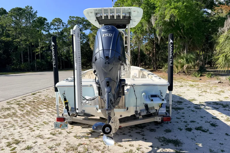 Slide: The Image of 2024 Key West 210 Bay Reef boat with Yamaha 150 engine, parked on sandy terrain. - 3