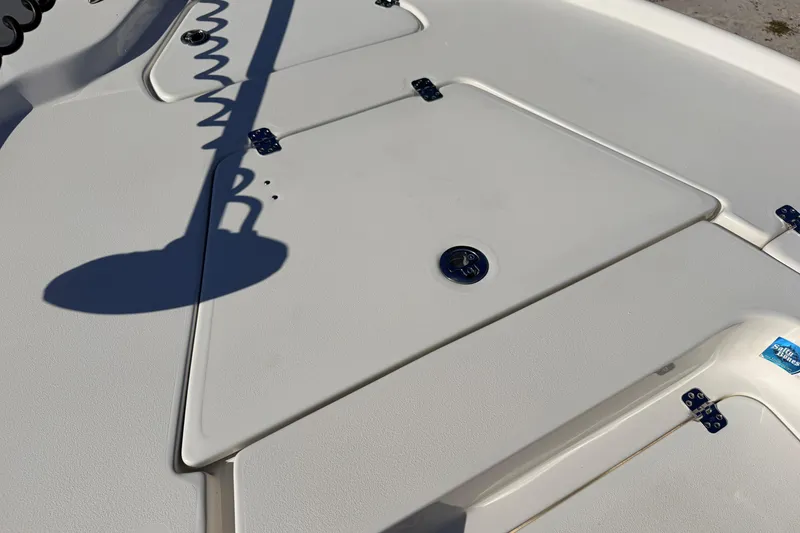 Slide: The Image of 2024 Key West 210 Bay Reef boat deck with storage compartments and shadow. - 33
