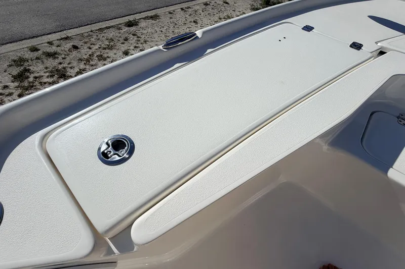 Slide: The Image of 2024 Key West 210 Bay Reef boat deck with storage compartment and latch. - 36