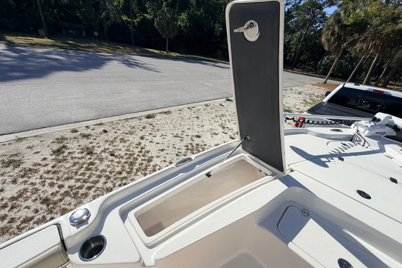 Slide: The Image of 2024 Key West 210 Bay Reef boat with open storage compartment, parked near a road. - 37