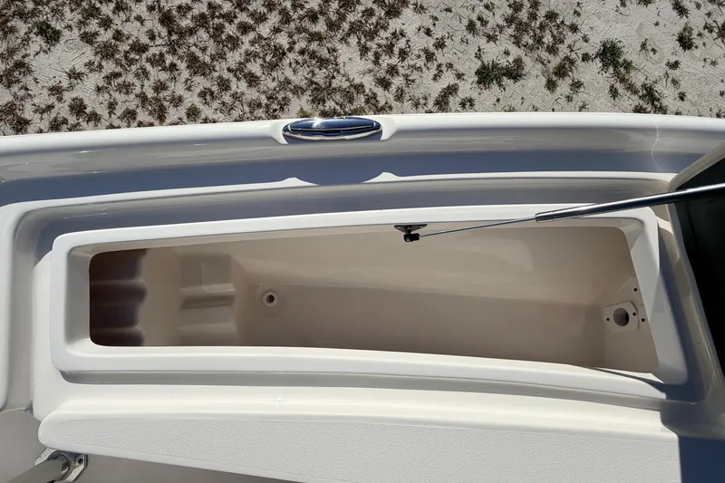 Slide: The Image of 2024 Key West 210 Bay Reef boat storage compartment, open on sandy beach. - 39