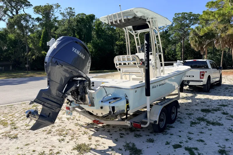Slide: The Image of 2024 Key West 210 Bay Reef boat on trailer, featuring Yamaha outboard motor. - 4