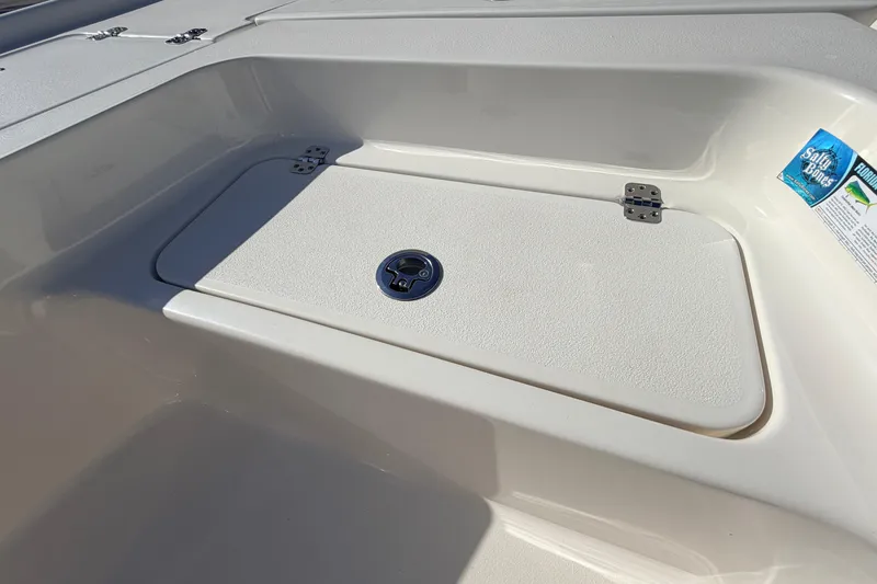 Slide: The Image of 2024 Key West 210 Bay Reef boat storage compartment with secure latch. - 40