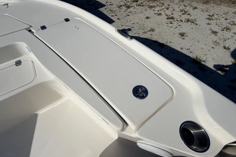 Slide: The Image of 2024 Key West 210 Bay Reef boat deck with storage compartments and cup holder. - 43