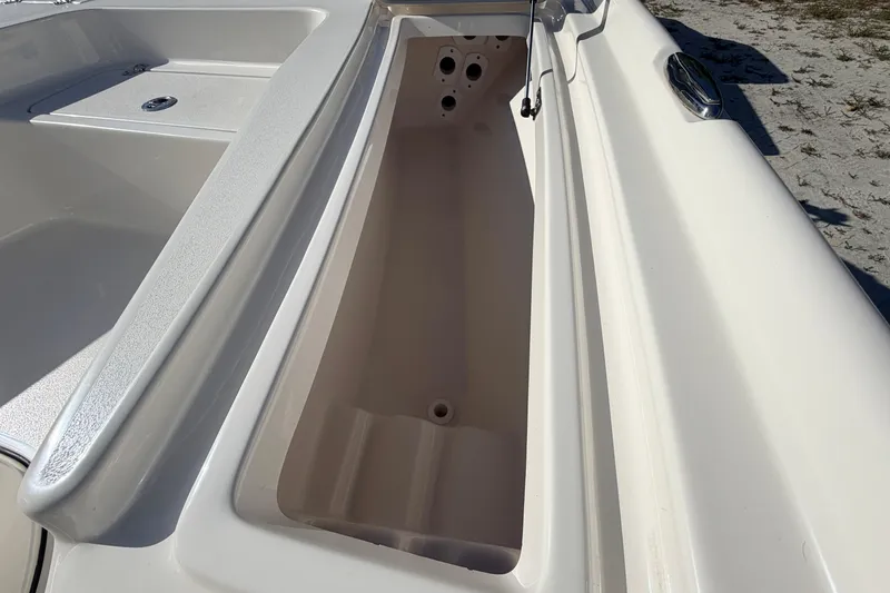 Slide: The Image of 2024 Key West 210 Bay Reef boat storage compartment, open and empty, showcasing interior design. - 45