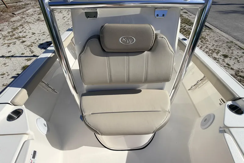 Slide: The Image of 2024 Key West 210 Bay Reef boat interior with beige seating and stainless steel frame. - 48