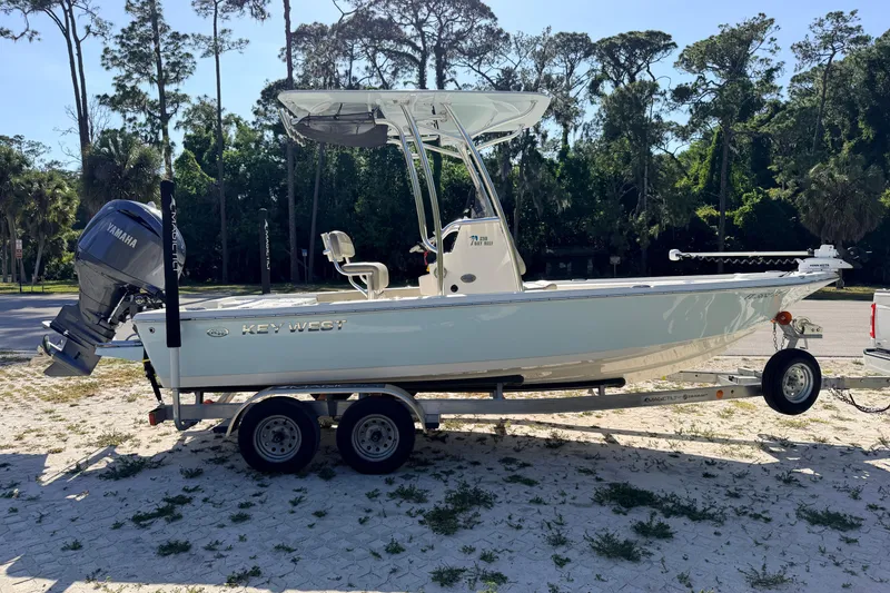 Slide: The Image of 2024 Key West 210 Bay Reef boat on trailer, parked outdoors. - 5