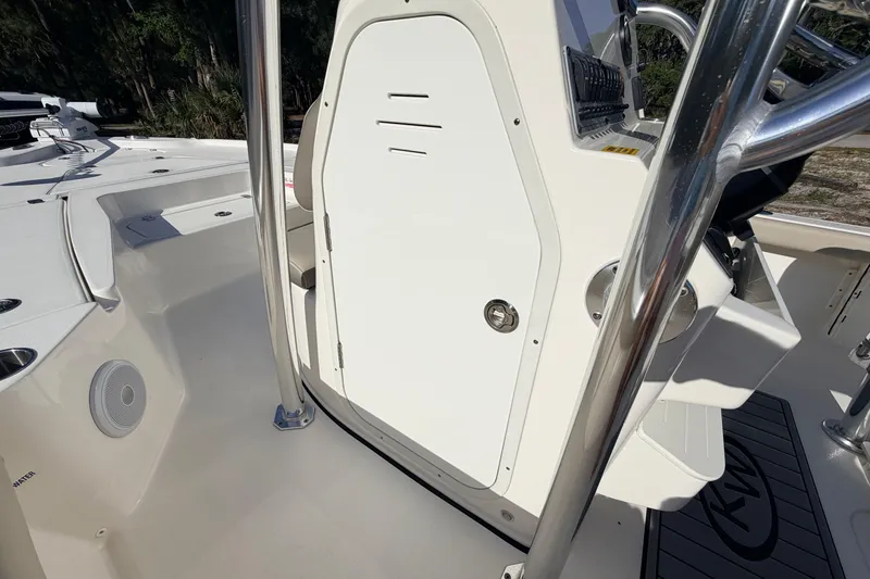 Slide: The Image of 2024 Key West 210 Bay Reef boat interior with console and seating area. - 56