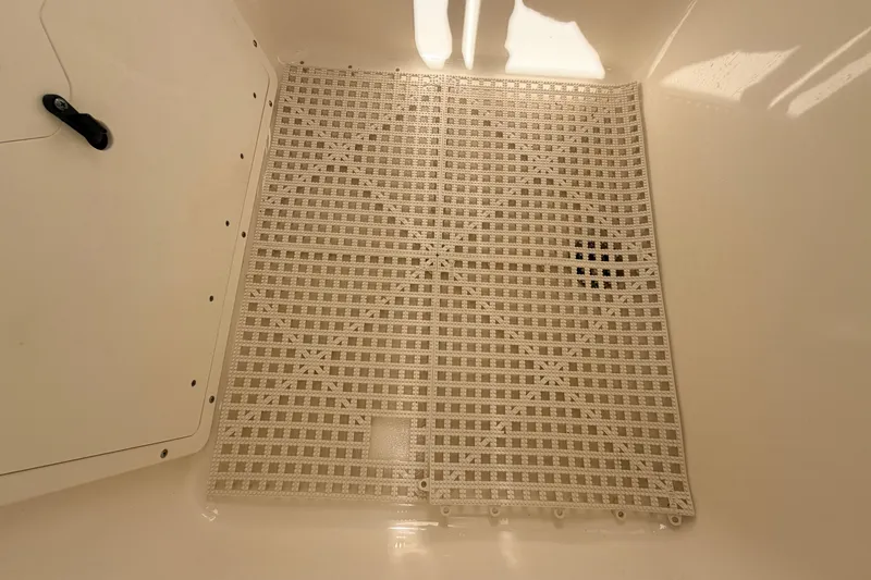 Slide: The Image of 2024 Key West 210 Bay Reef boat storage compartment with grid flooring. - 60