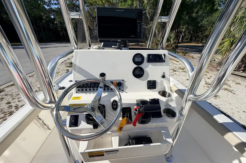 Slide: The Image of 2024 Key West 210 Bay Reef boat console with steering wheel and navigation equipment. - 67