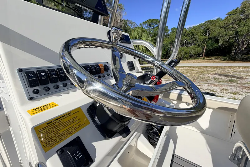 Slide: The Image of 2024 Key West 210 Bay Reef boat steering wheel and control panel close-up. - 74