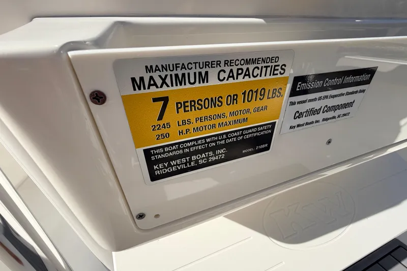 Slide: The Image of 2024 Key West 210 Bay Reef capacity label, showing maximum 7 persons or 1019 lbs. - 76