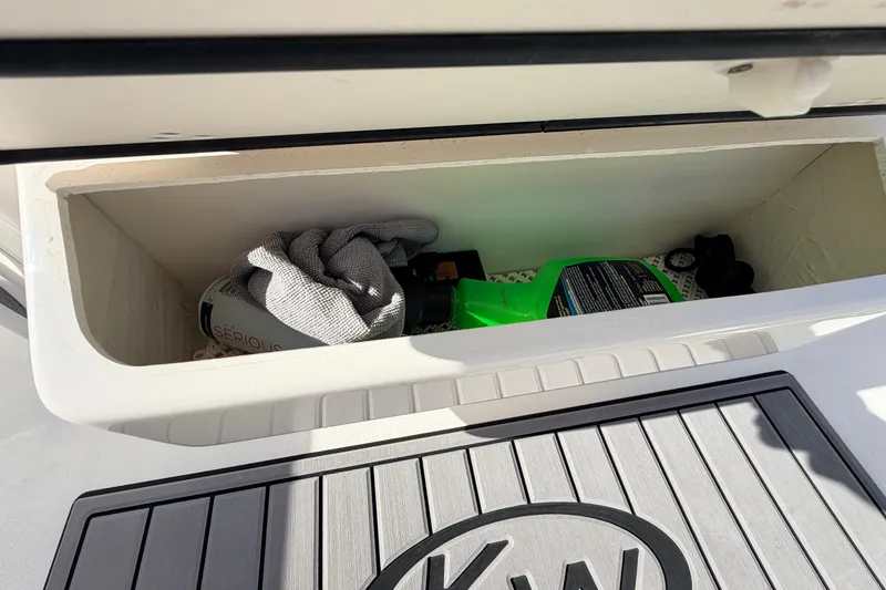 Slide: The Image of Storage compartment on a 2024 Key West 210 Bay Reef boat with cleaning supplies. - 78