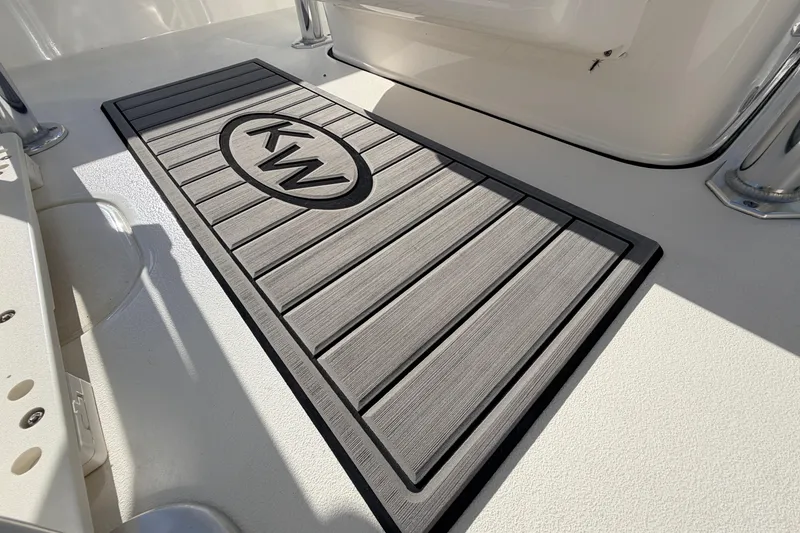 Slide: The Image of 2024 Key West 210 Bay Reef boat deck with KW logo mat. - 79